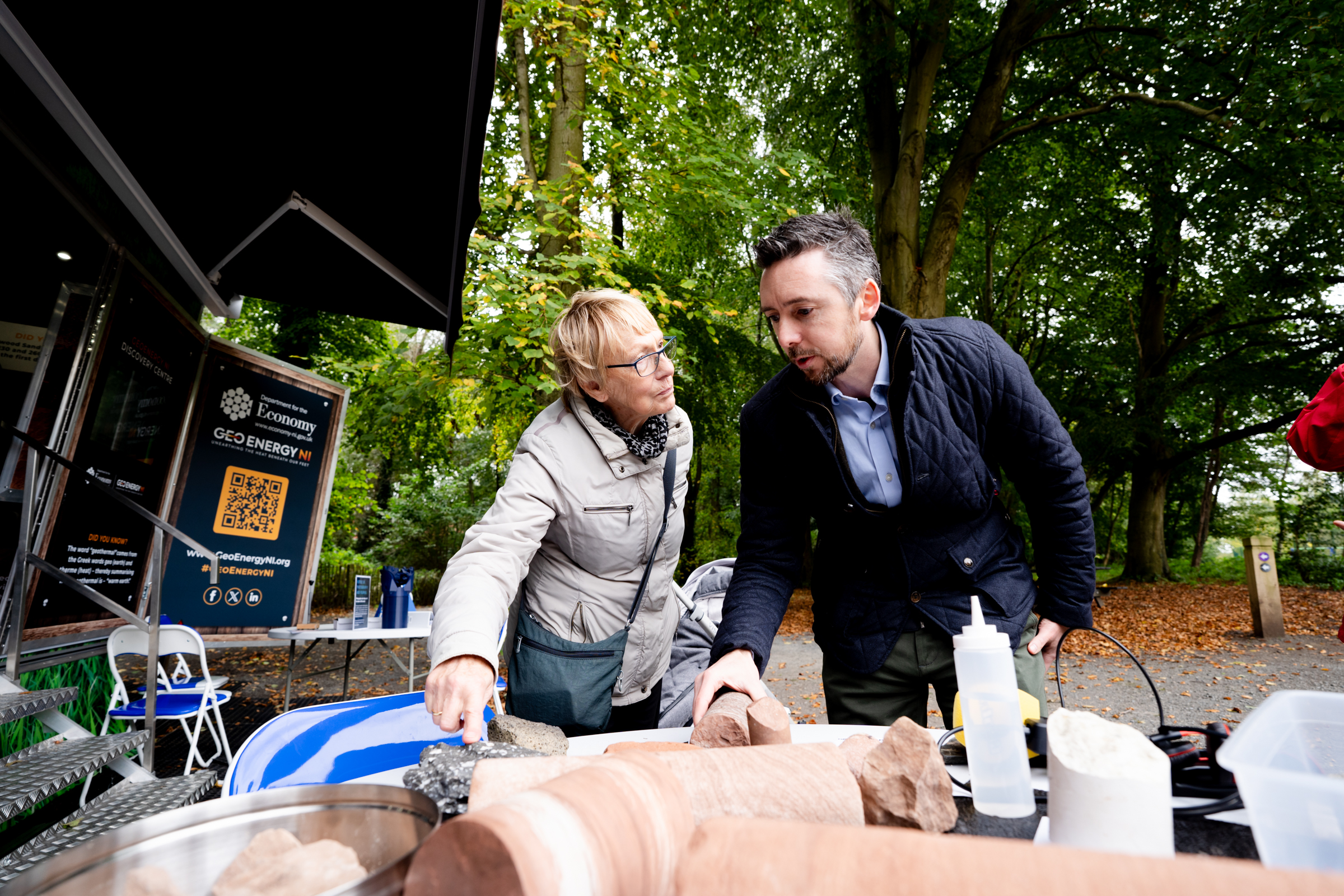 A GeoEnergy ambassador with a member of the public discussing the rocks obtained from the Northern Ireland subsurface.
