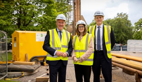 Economy Minister Conor Murphy, Minister for Finance Dr Caoimhe Archibald and US Special Envoy to Northern Ireland for Economic Affairs, Joe Kennedy III standing infront of the drill in the drill site.